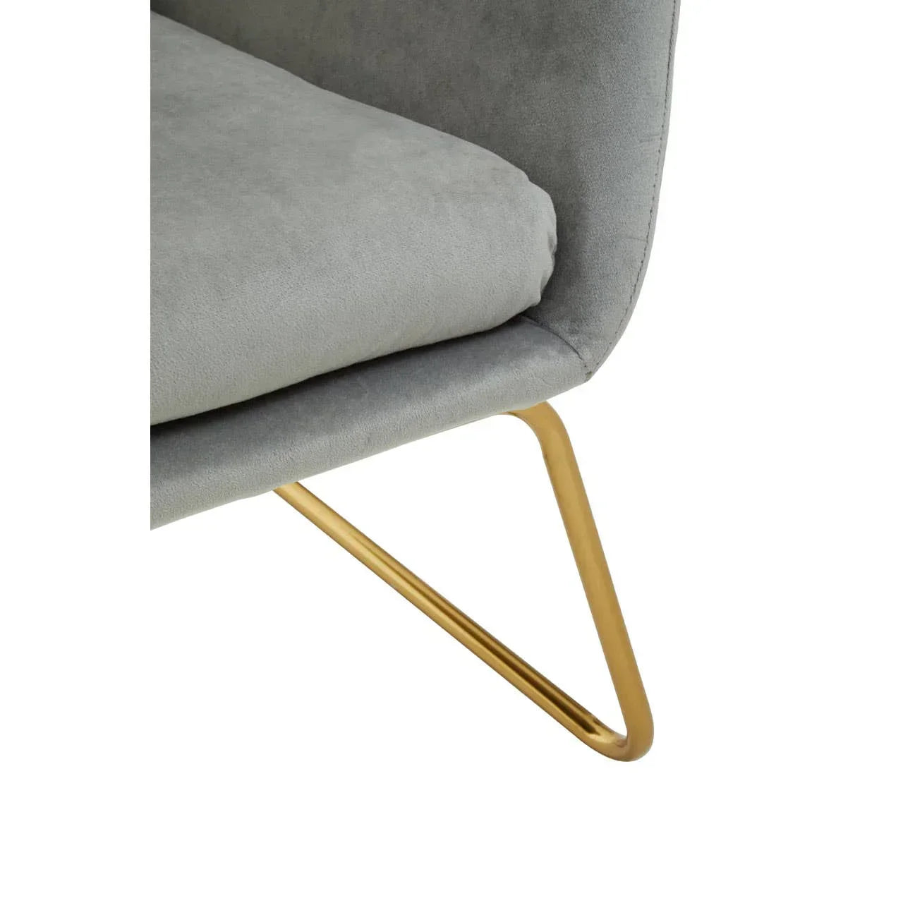 Grey fabric chair with gold metal legs, close-up of seat and leg detail