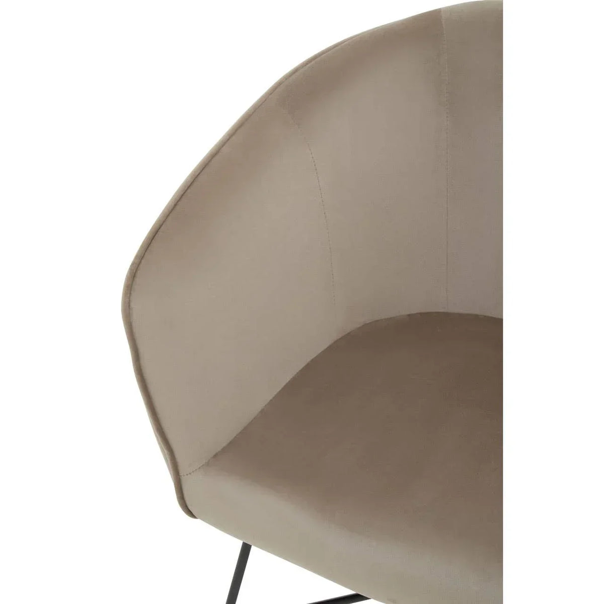 Close up of beige velvet armchair seat with curved backrest and black metal leg