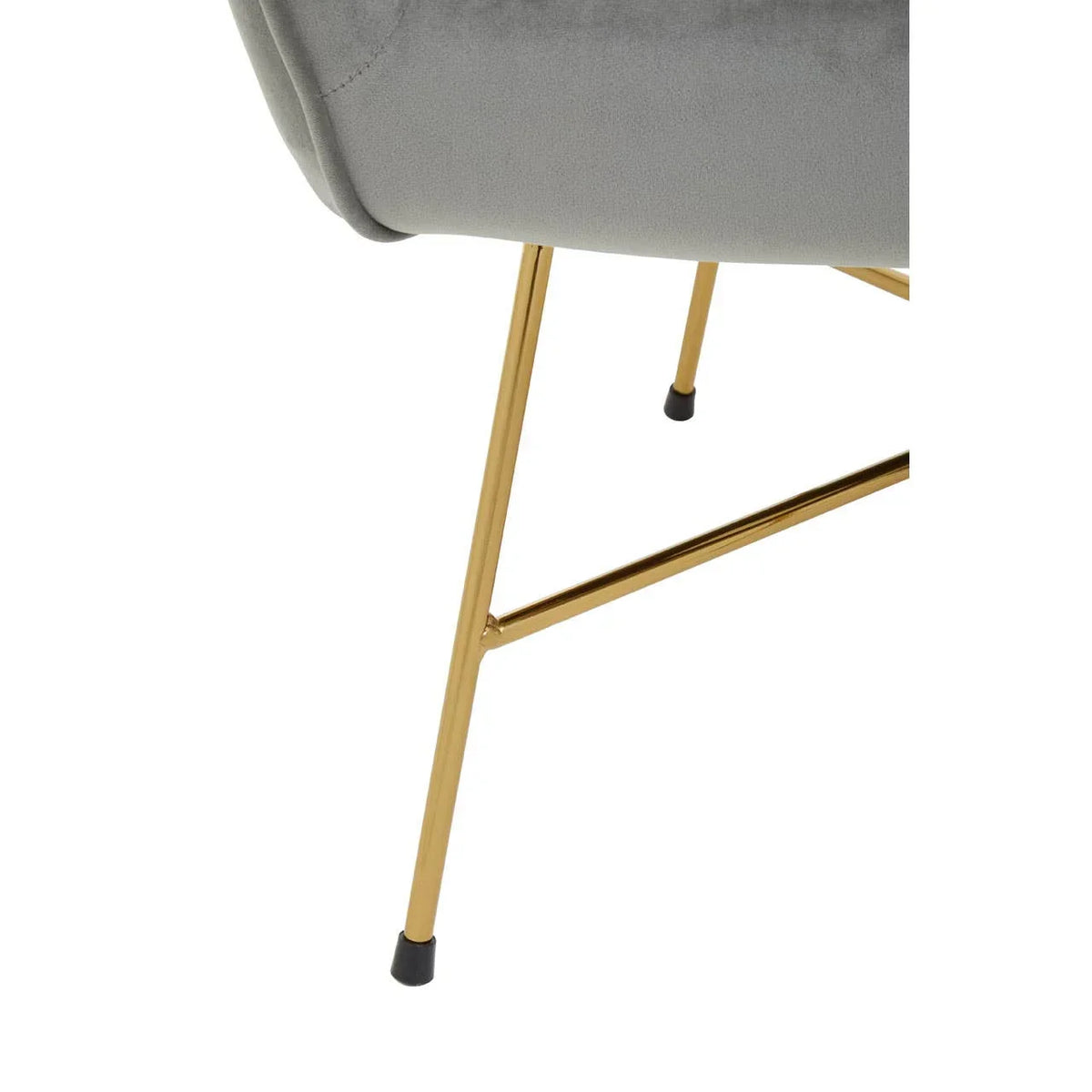 Velvet dining chair with gold metal legs and grey upholstered seat close-up