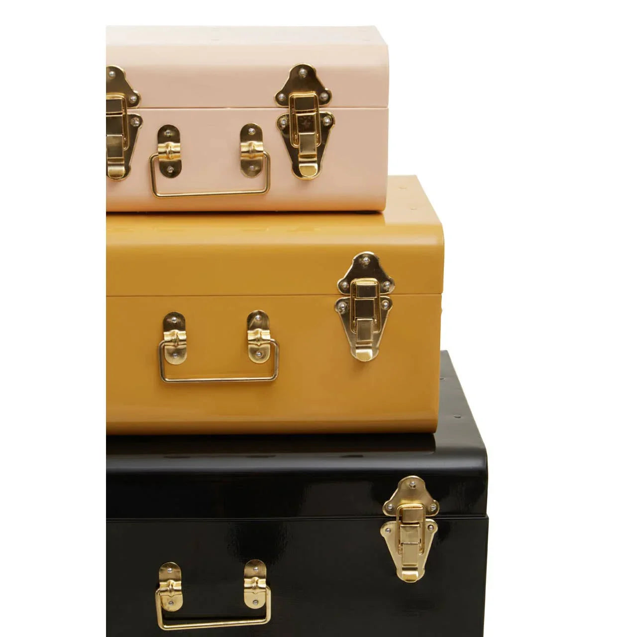 Stack of three metal storage trunks in pink, yellow, and black with gold handles and latches