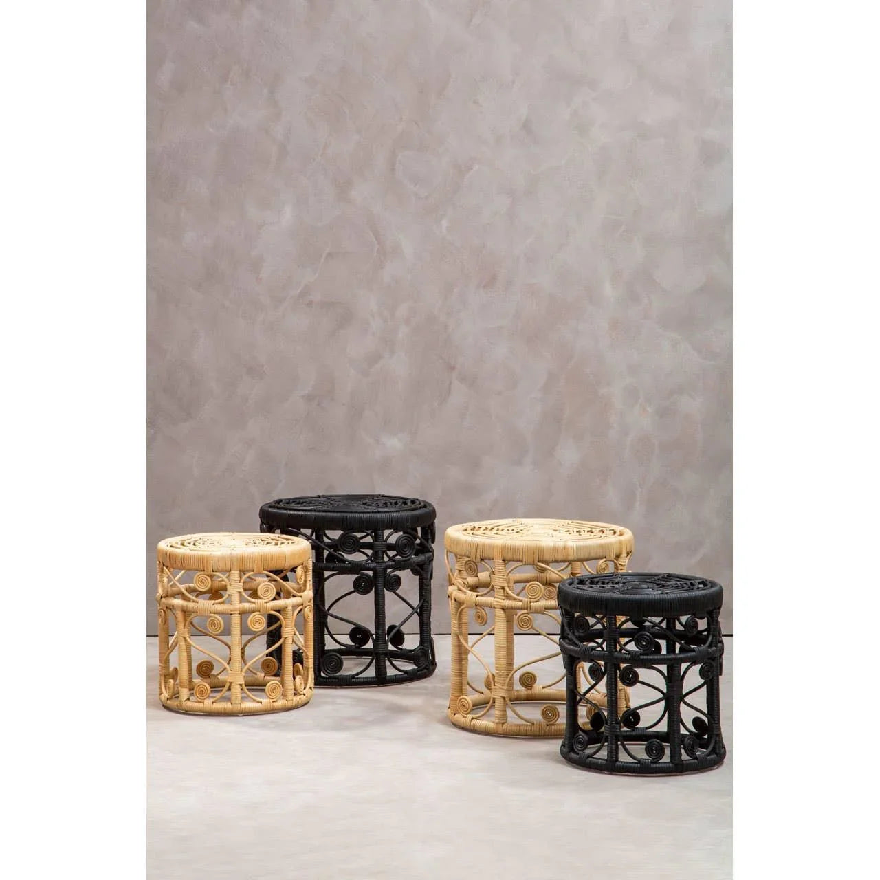 Round rattan side tables in natural and black finish with decorative scroll detailing