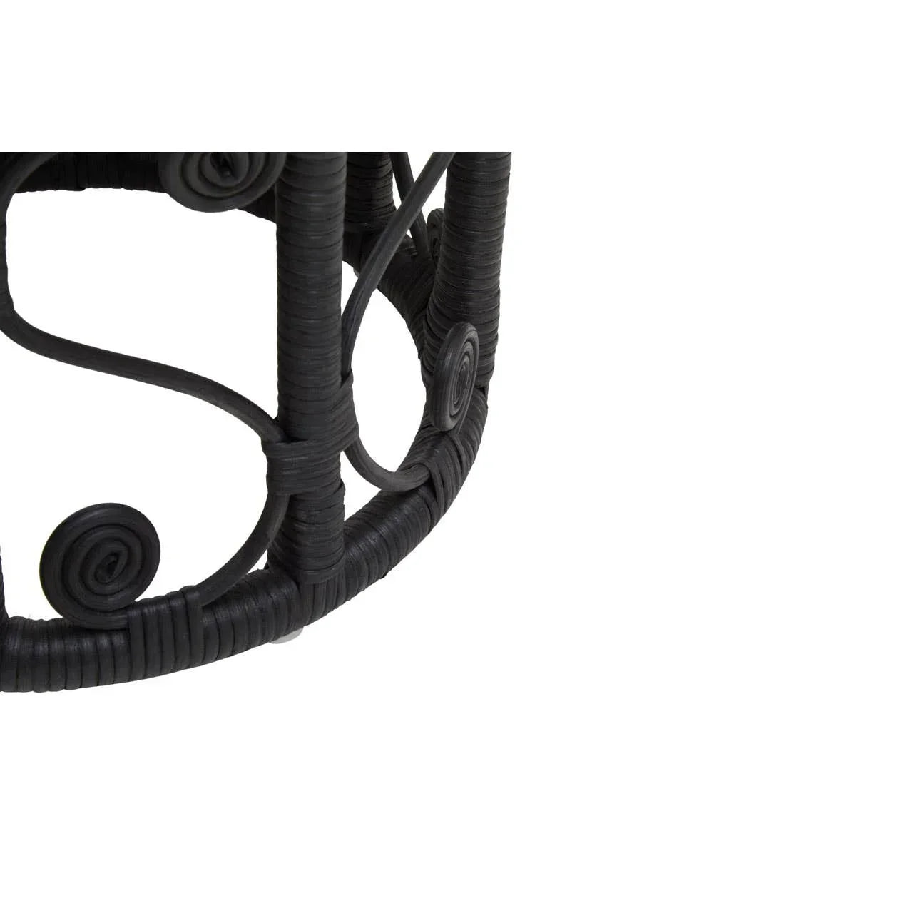 Close up of black rattan table base with decorative woven swirl detail