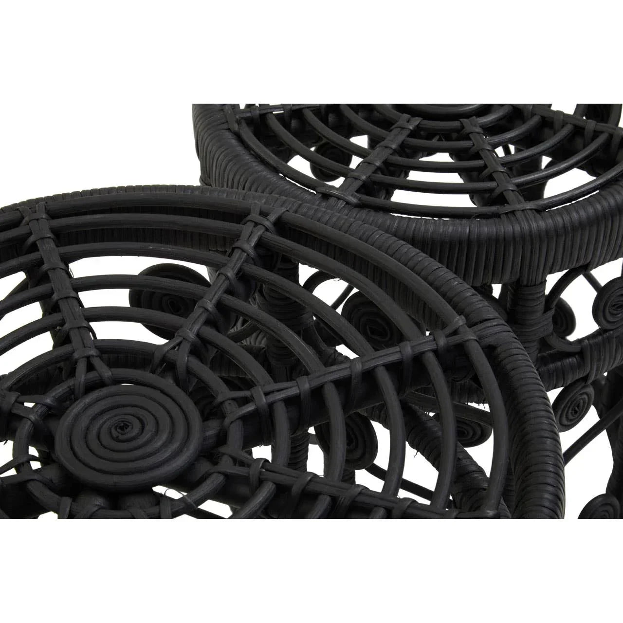 Black rattan side table top detail with circular woven pattern and textured finish