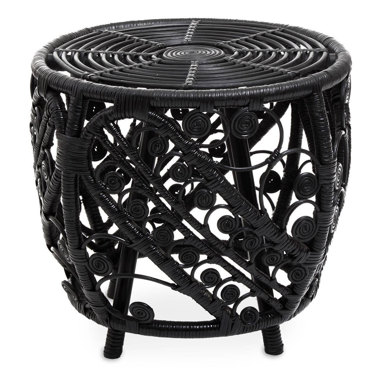 Black rattan side table with intricate swirl pattern and round top