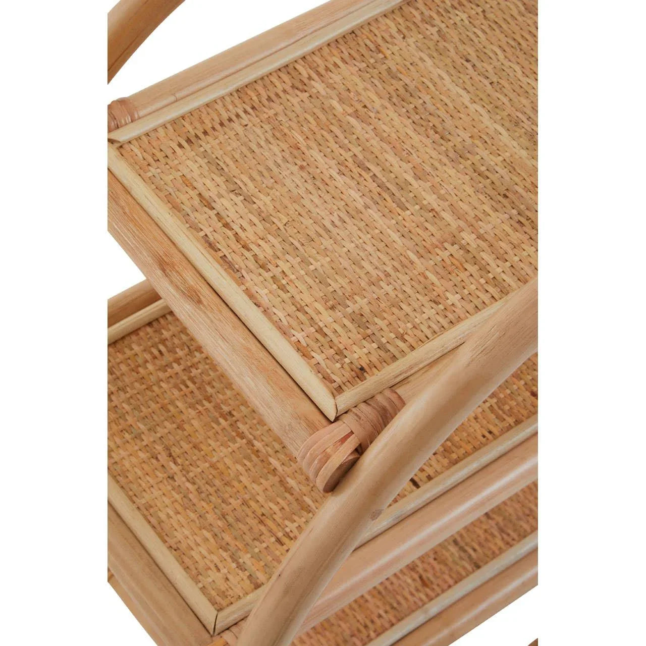 Closeup of woven rattan shelving unit with natural wood frame and curved support detail