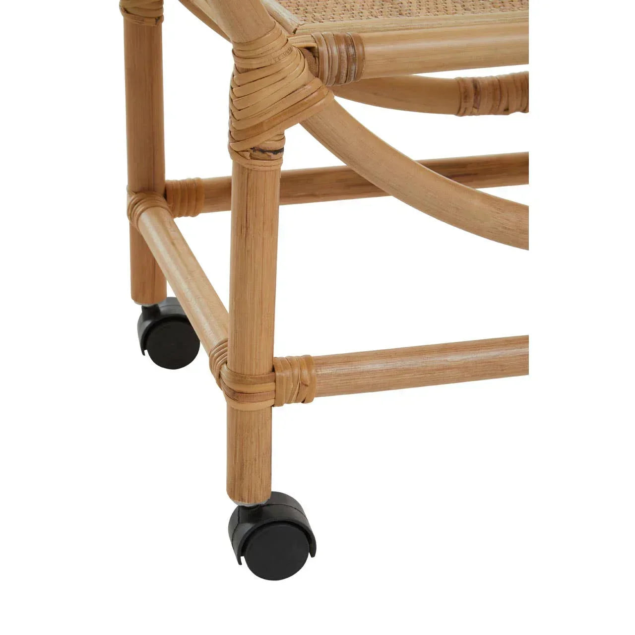 Closeup of rattan chair leg with black caster wheels and woven cane seat detail