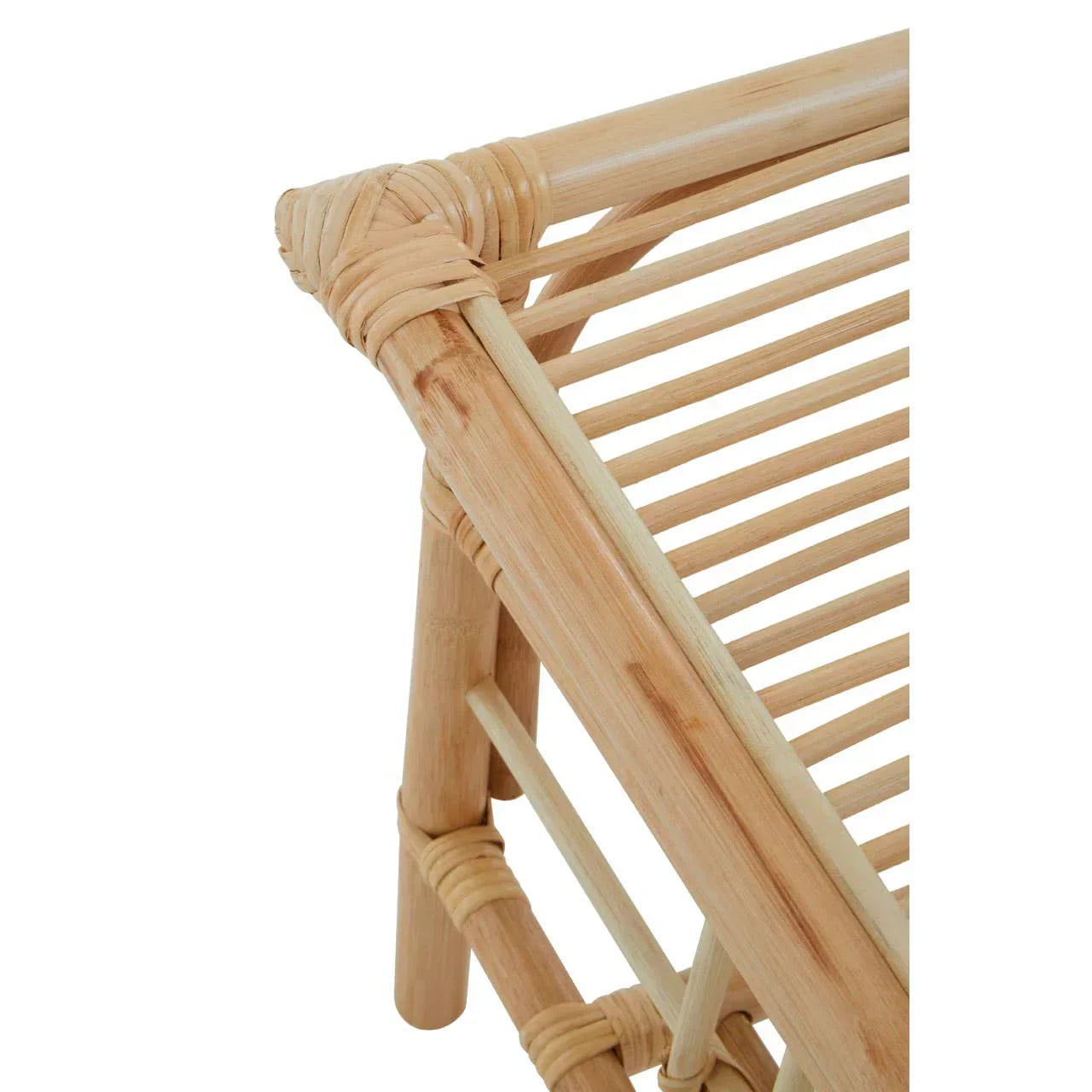 Close-up of natural rattan furniture frame showing woven corner and slatted design