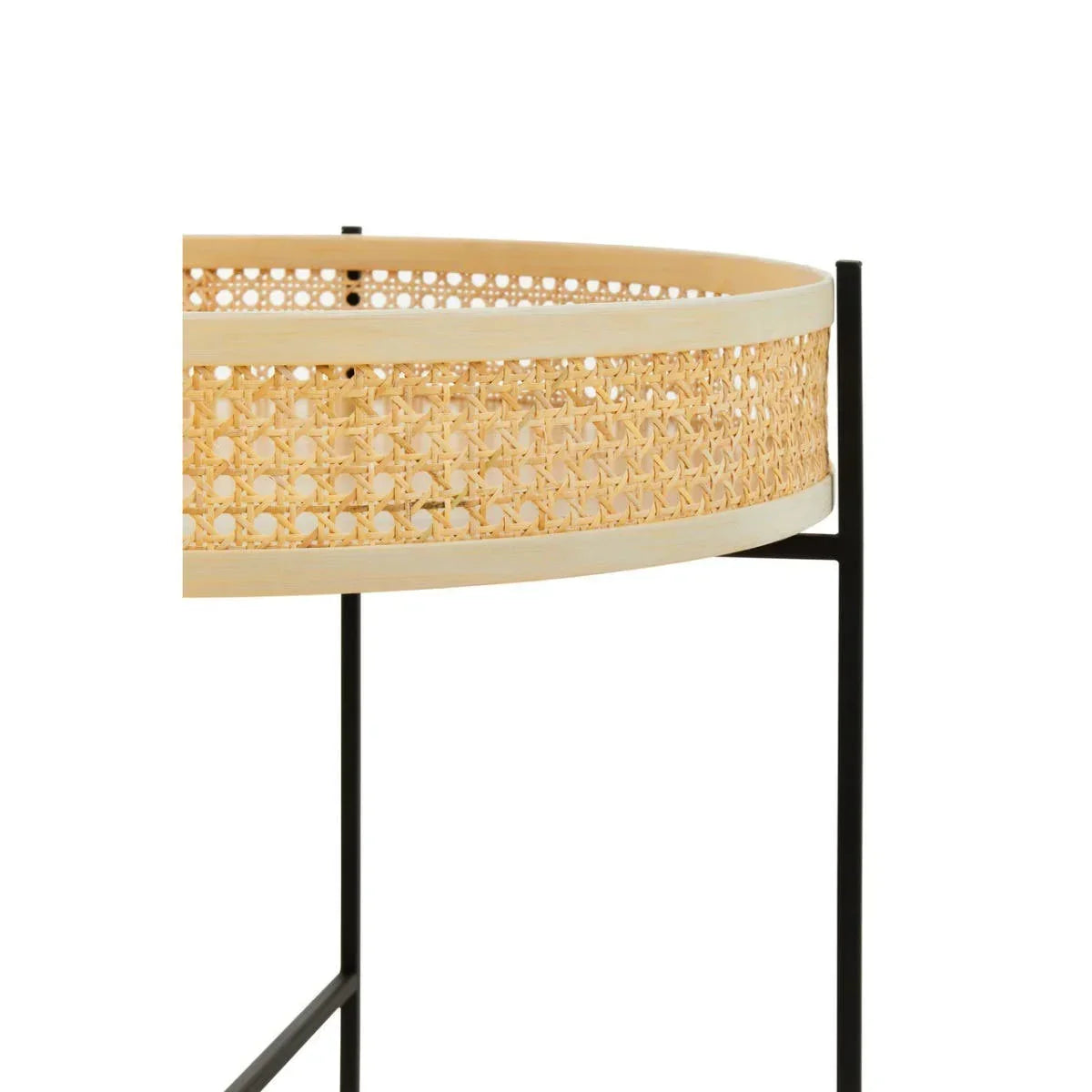 Round rattan side table with woven cane detail and black metal legs, close up view