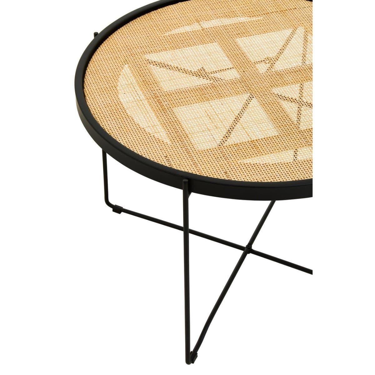 Round rattan coffee table with black metal frame and cane weave top, partial side angle