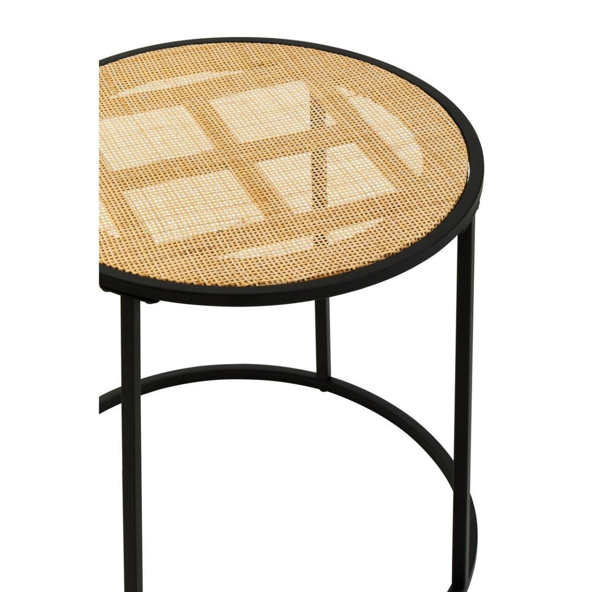Round cane side table with black metal frame and woven rattan top, partial closeup view
