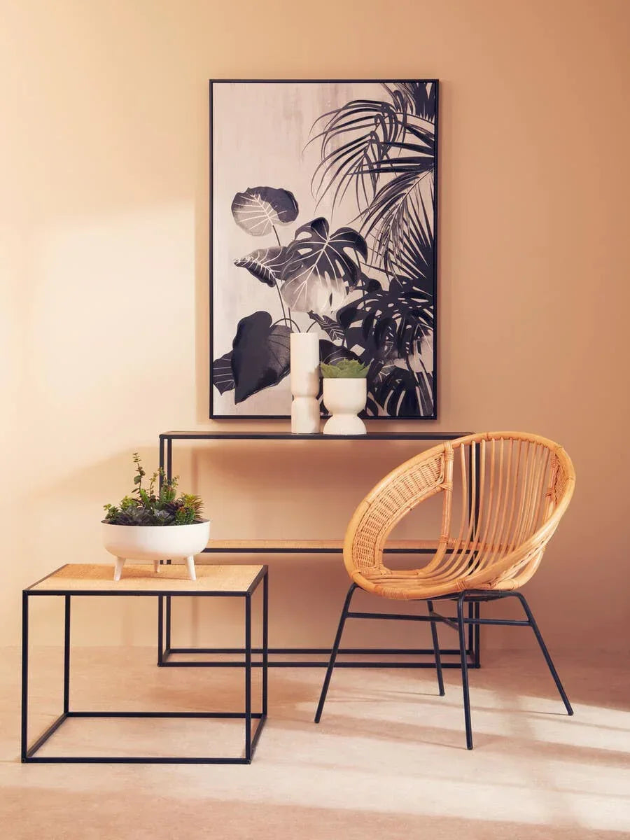 Rattan accent chair and side table with metal frame in modern living room setting