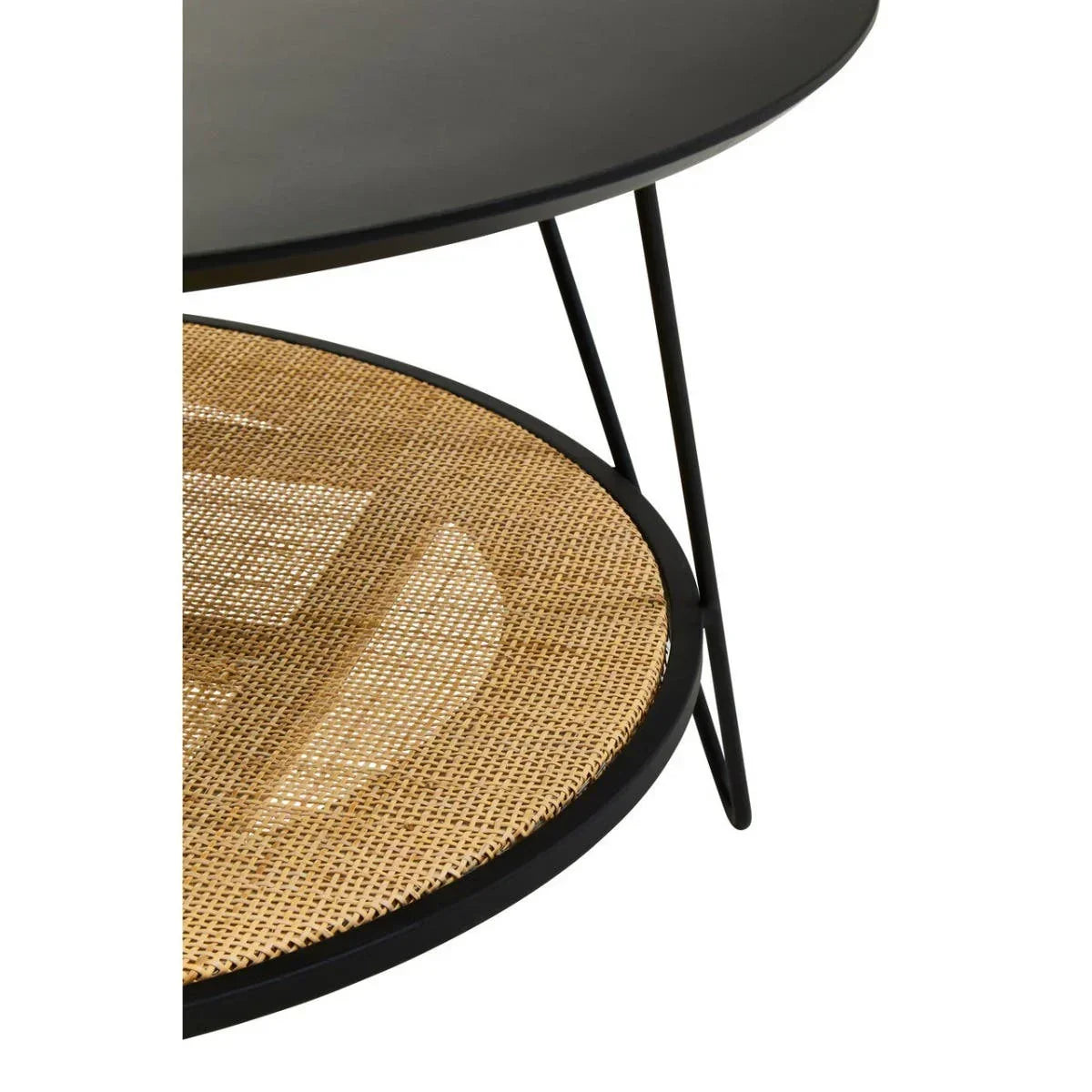 Round black metal coffee table with rattan shelf and slim hairpin legs, close-up view