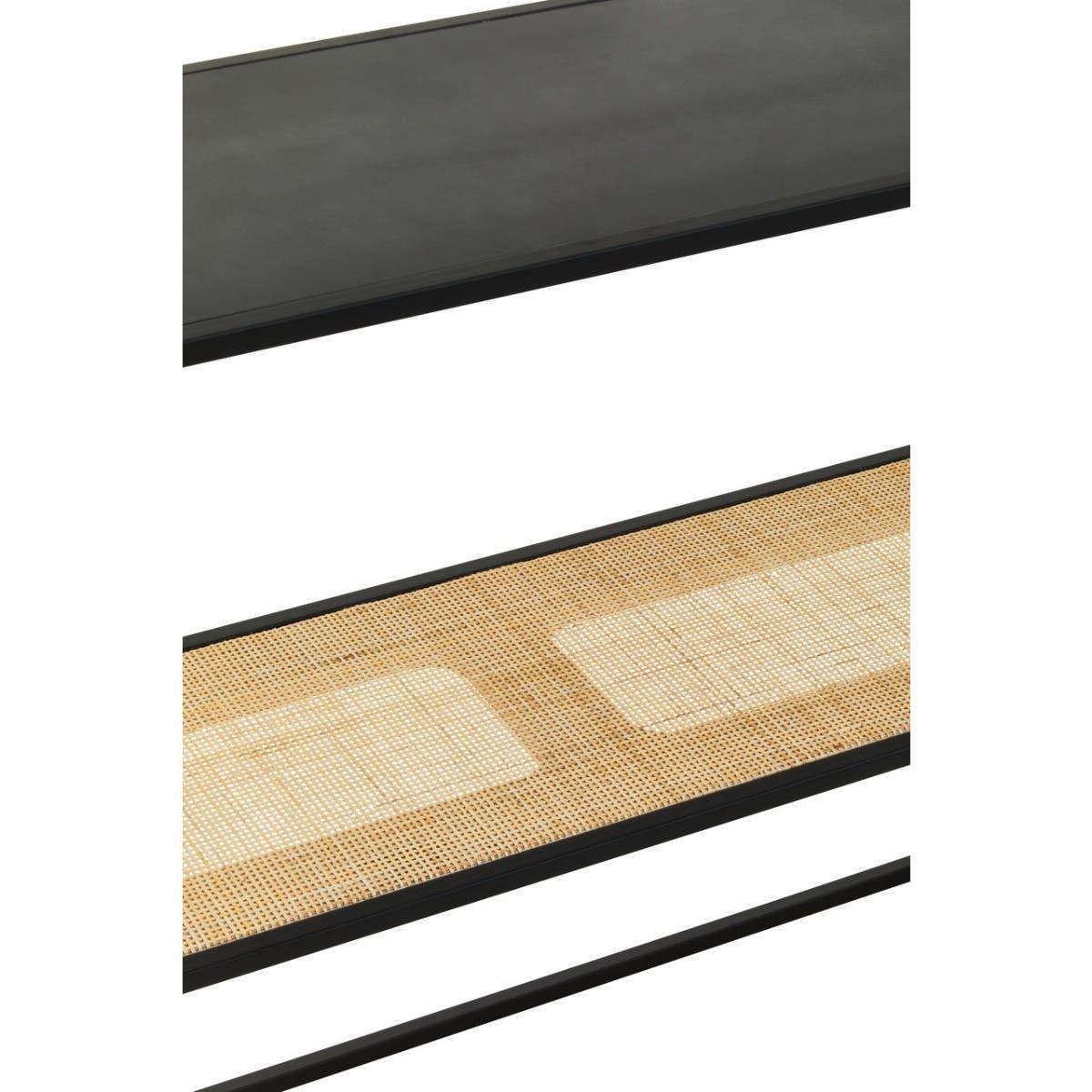 Close-up of black tabletop and rattan shelf detail on modern furniture piece