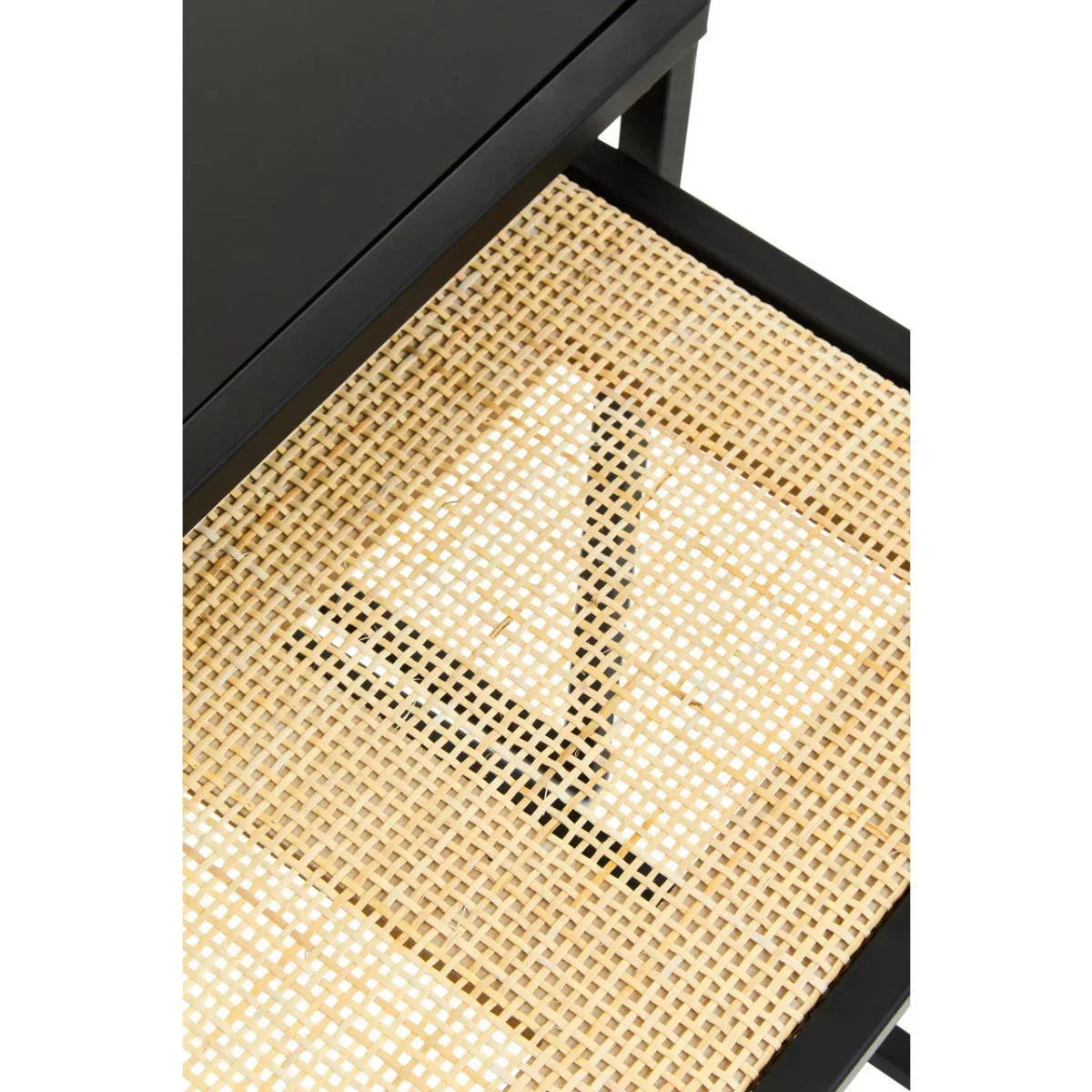 Closeup of black side table with woven cane shelf detail
