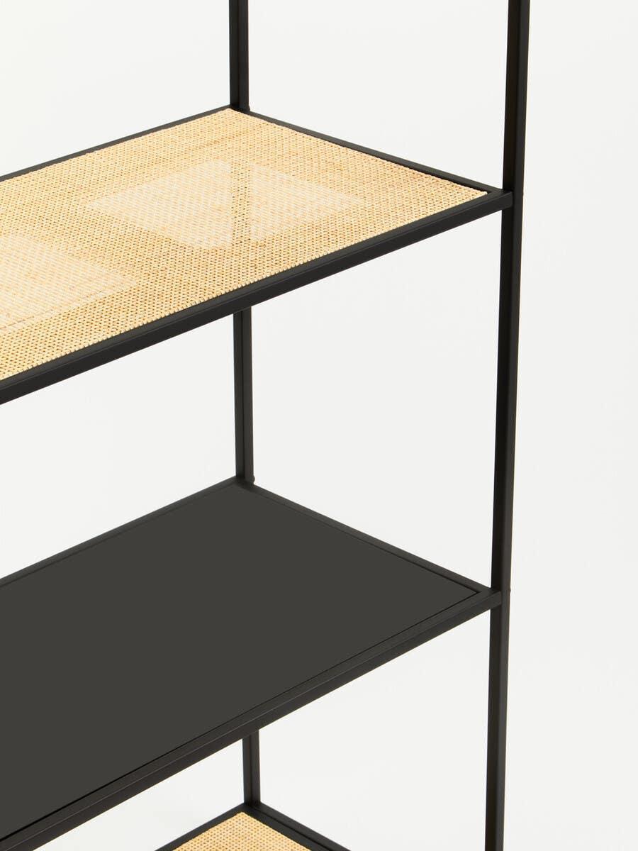Black metal shelving unit with rattan and solid black shelves, close-up view
