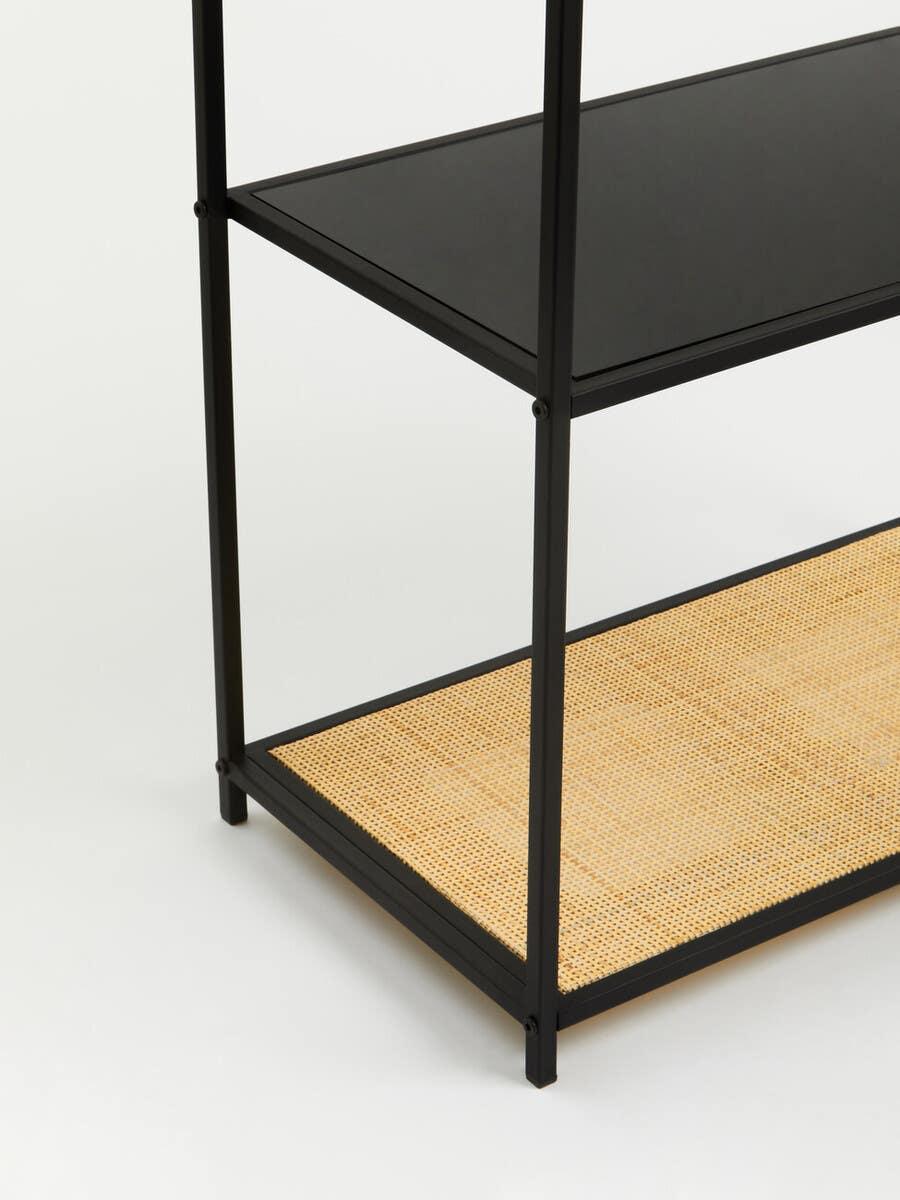 Black metal shelving unit with glass and woven rattan shelf detail