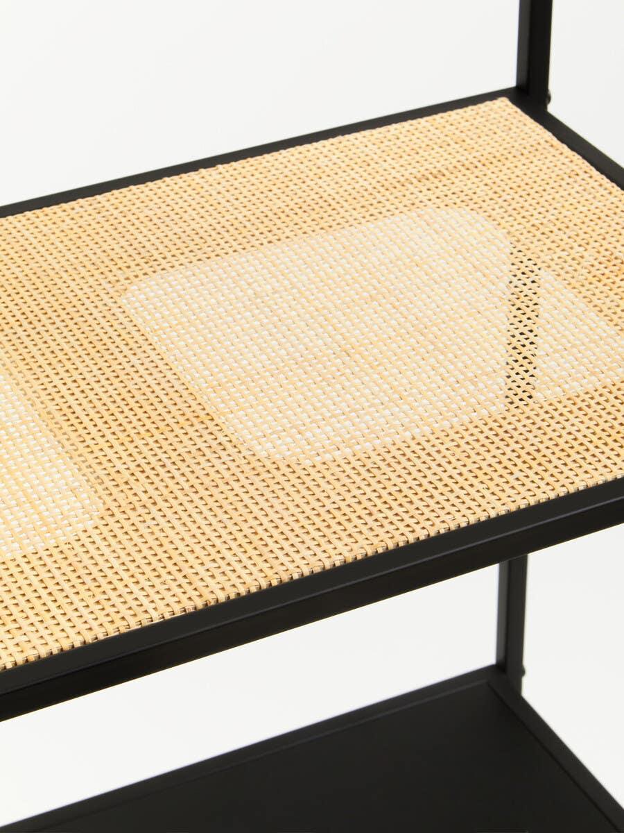 Close-up of woven rattan shelf with black metal frame, modern furniture detail