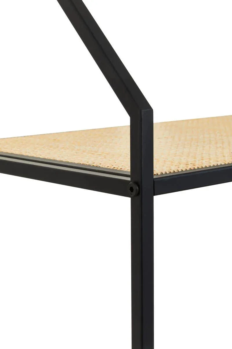 Close up of black metal furniture frame with woven rattan shelf surface