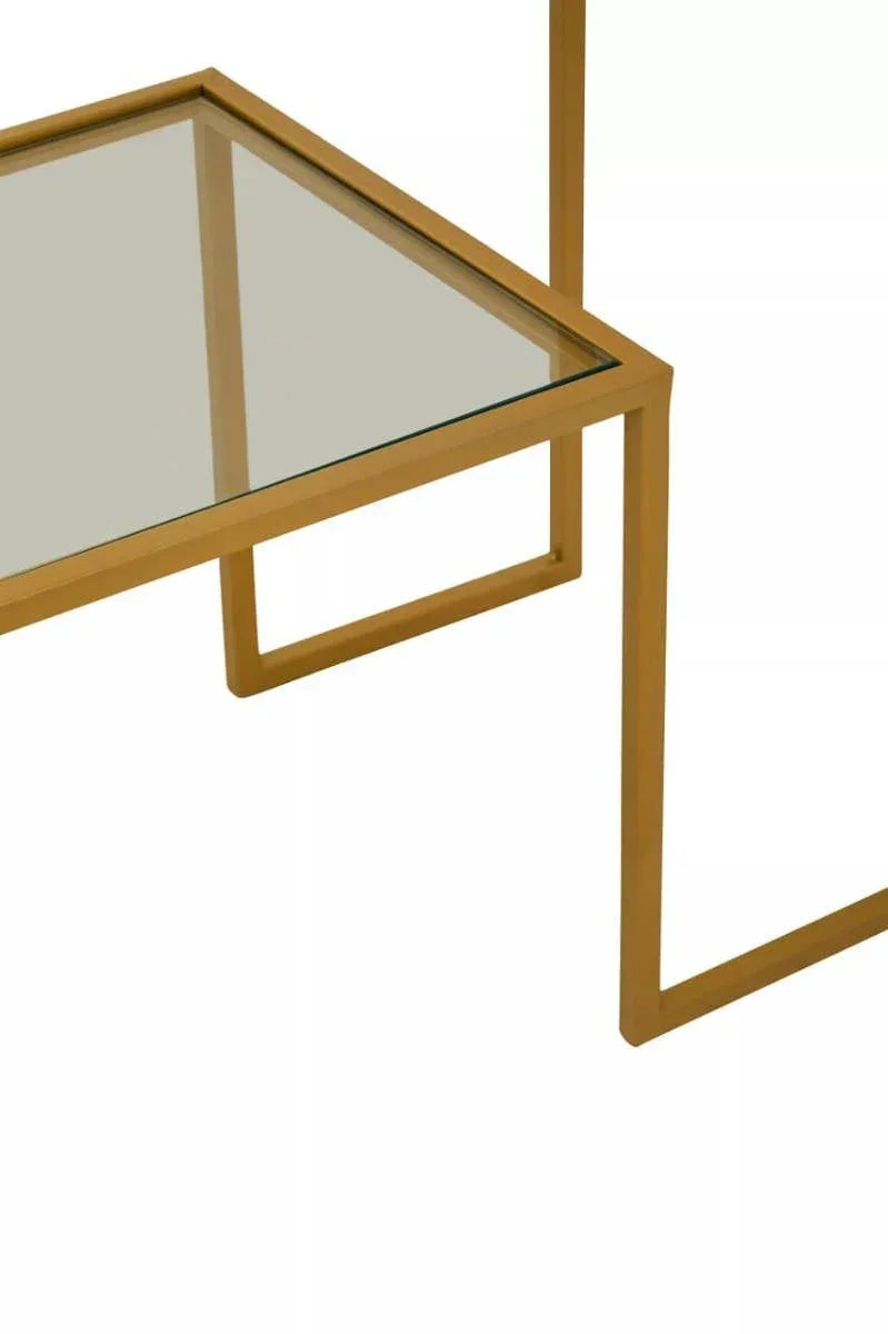 Close-up of gold metal and glass coffee table corner with modern geometric frame