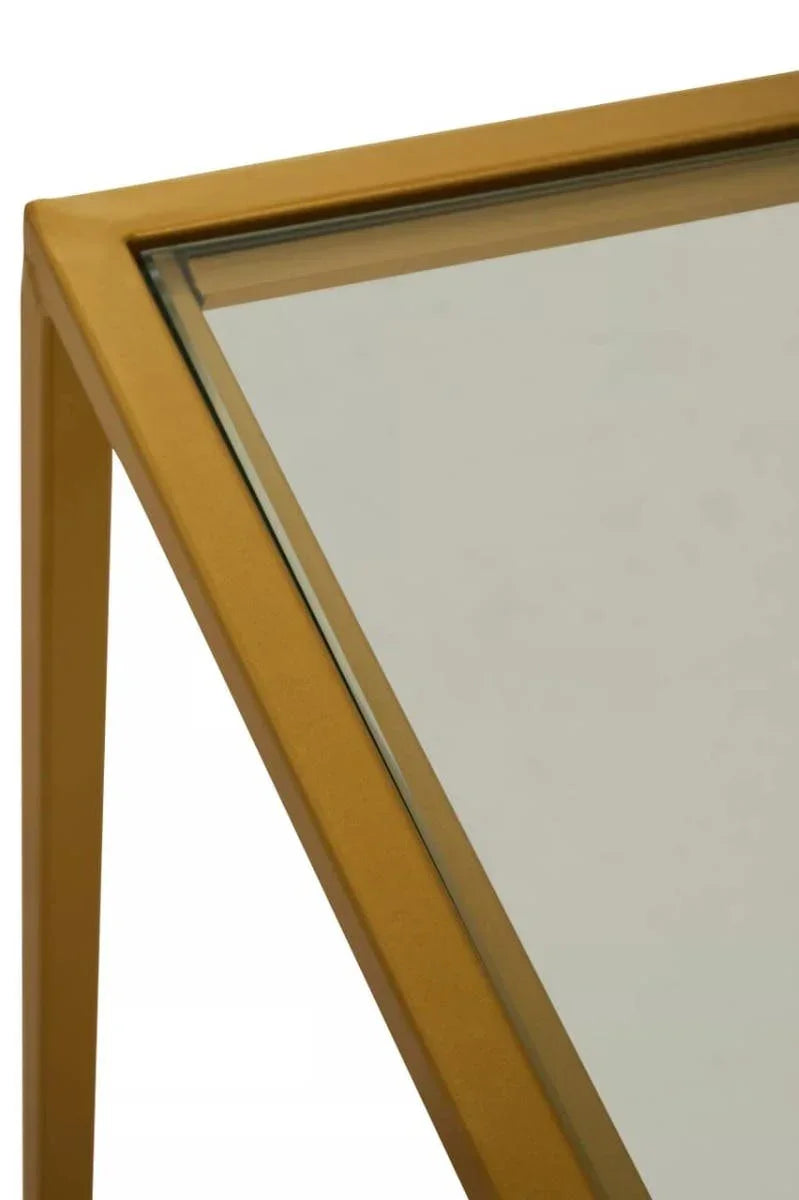 Close-up of gold metal frame glass table corner