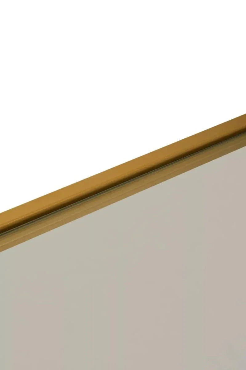 Close view of gold metal mirror frame with glass panel