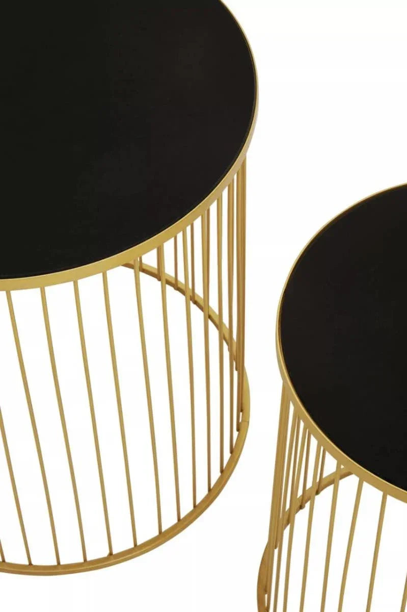 Set of two round side tables with black tops and gold metal frames, modern design