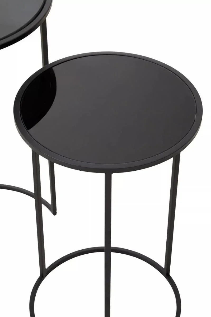Black round glass side table with slim metal frame, modern minimalist design