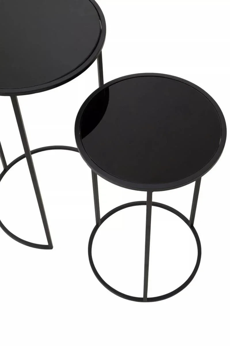 Set of two round black glass nesting side tables with metal frames, top view