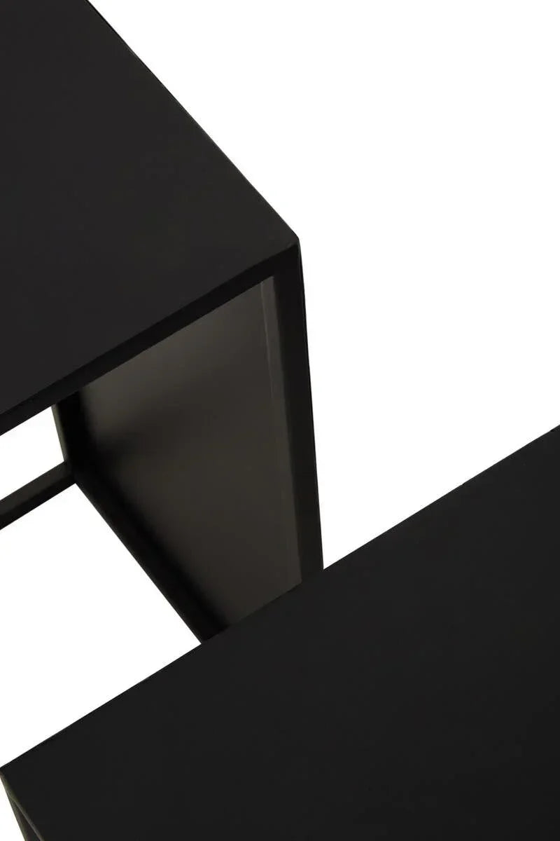 Closeup of black metal nesting tables with rectangular tops and sharp modern edges
