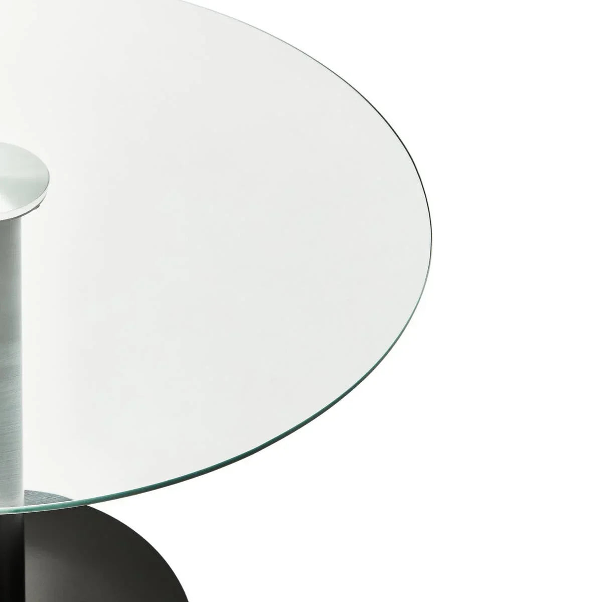 Round glass dining table top with metal support leg close-up