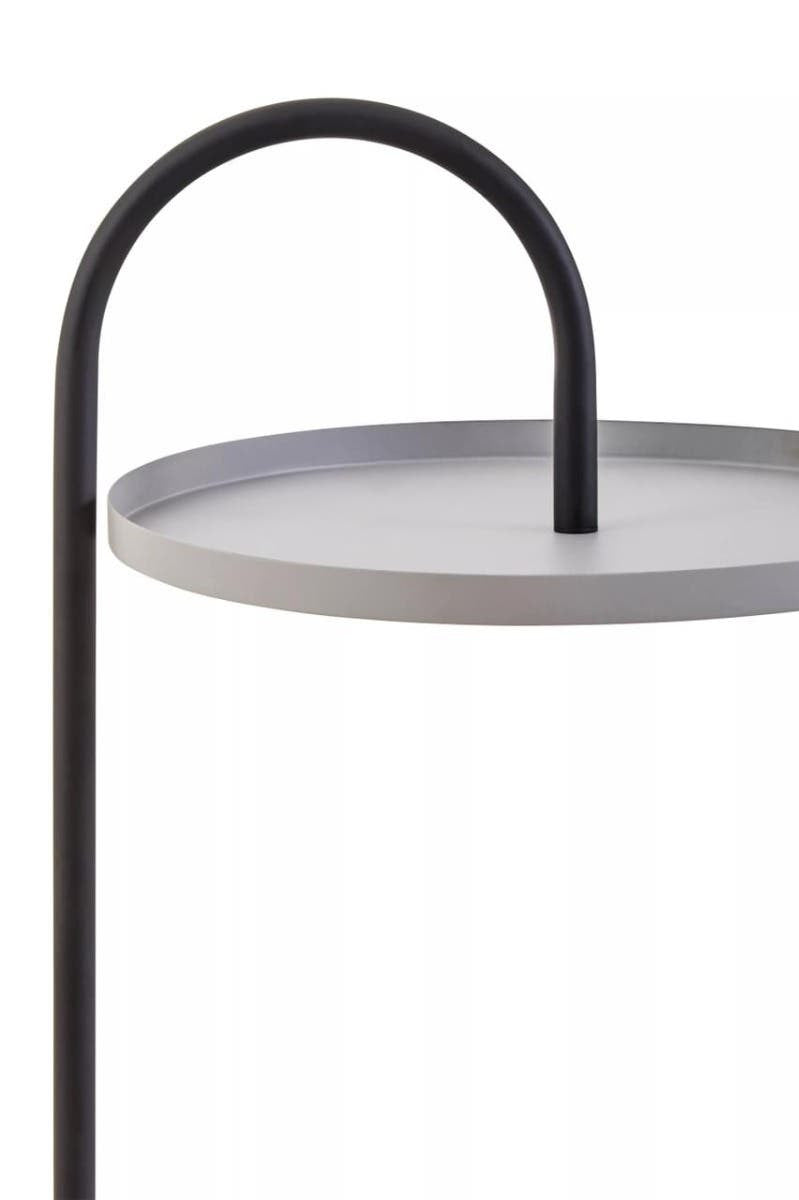 A modern side table featuring a circular grey tabletop with a sleek black metal frame. The frame has a curved handle design that arches over the tabletop, creating a minimalist and stylish look suitable for contemporary home decor