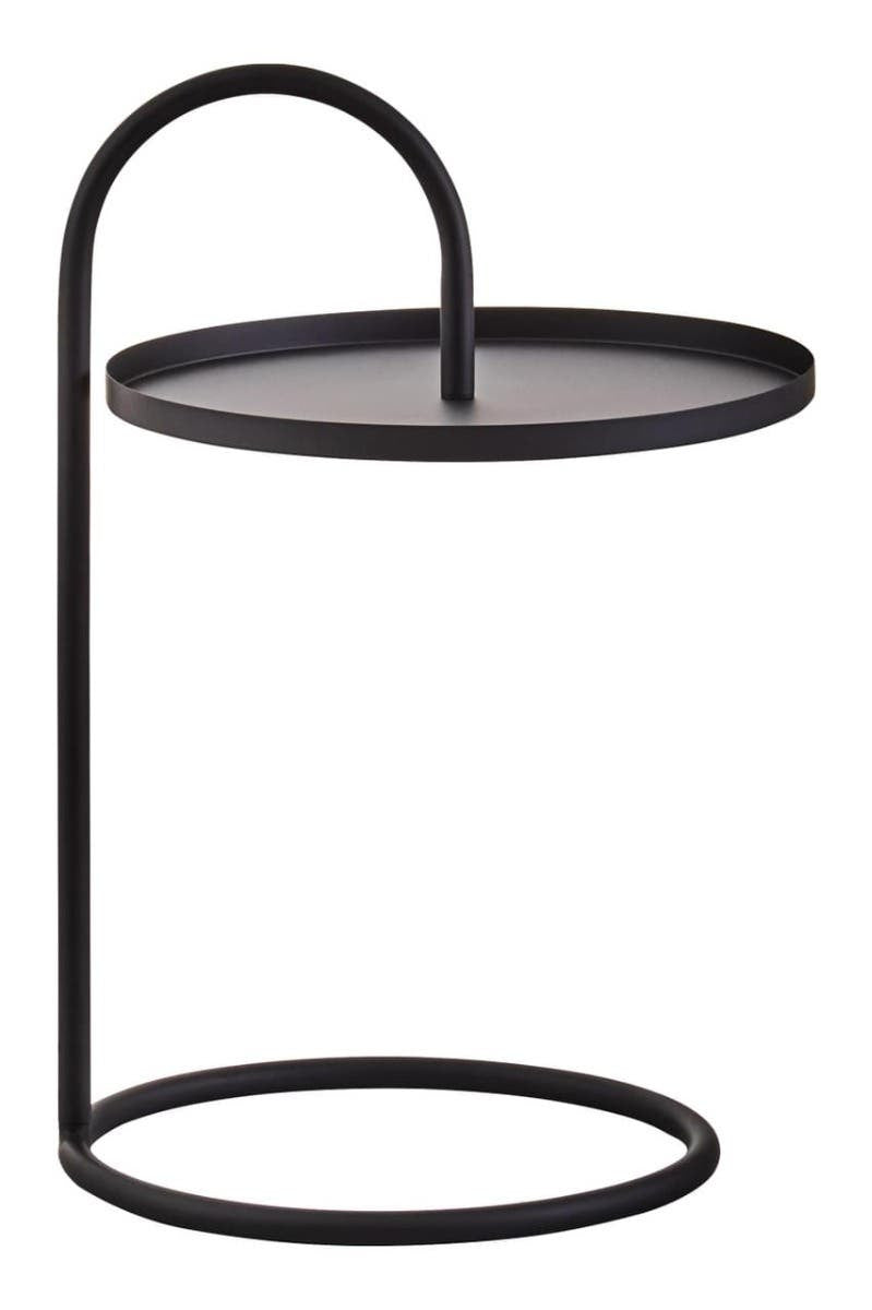 A modern black hanging top side table with a circular surface and a minimalist frame, featuring a curved support that connects the top to a round base. The design emphasizes simplicity and elegance, suitable for various home decor styles