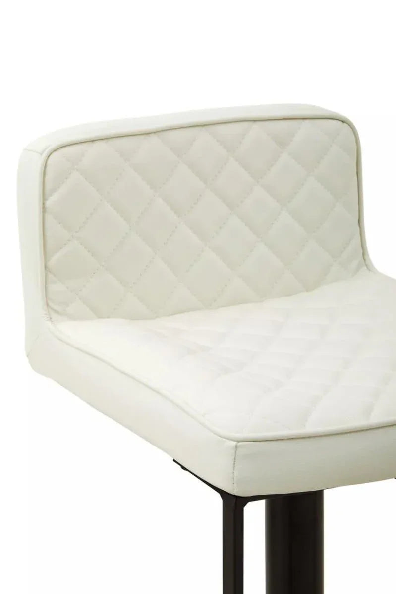Close view of white quilted bar stool seat with black metal legs