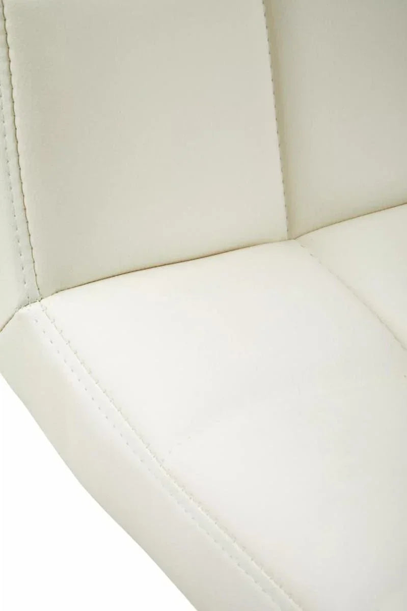 Close-up of cream faux leather dining chair upholstery with stitched detail
