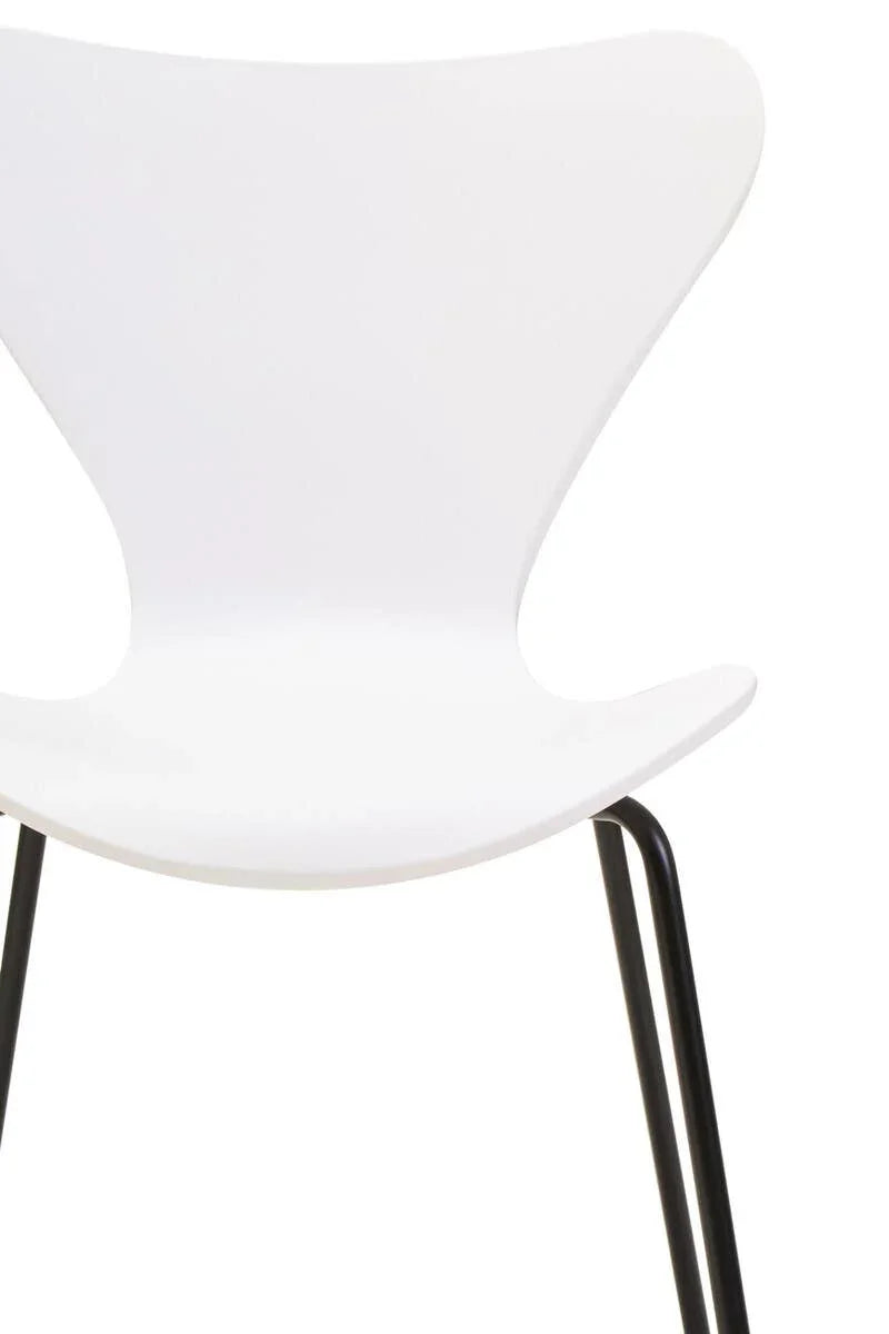 White dining chair with curved backrest and black metal legs, partial close-up view