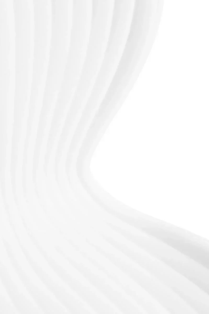White curved chair back with ribbed texture, close-up view of modern furniture detail