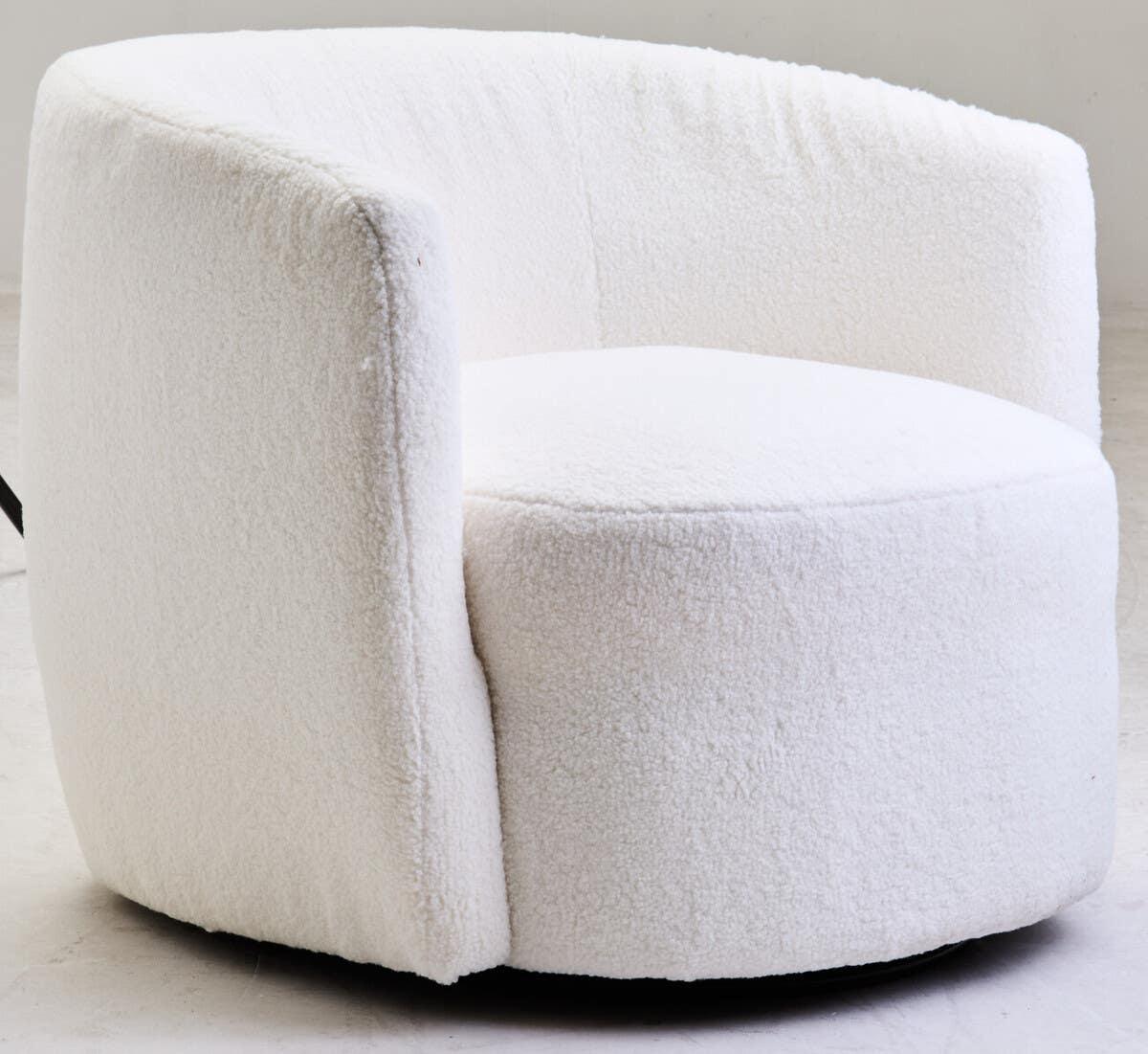 White boucle accent chair with curved back and plush upholstery on neutral floor