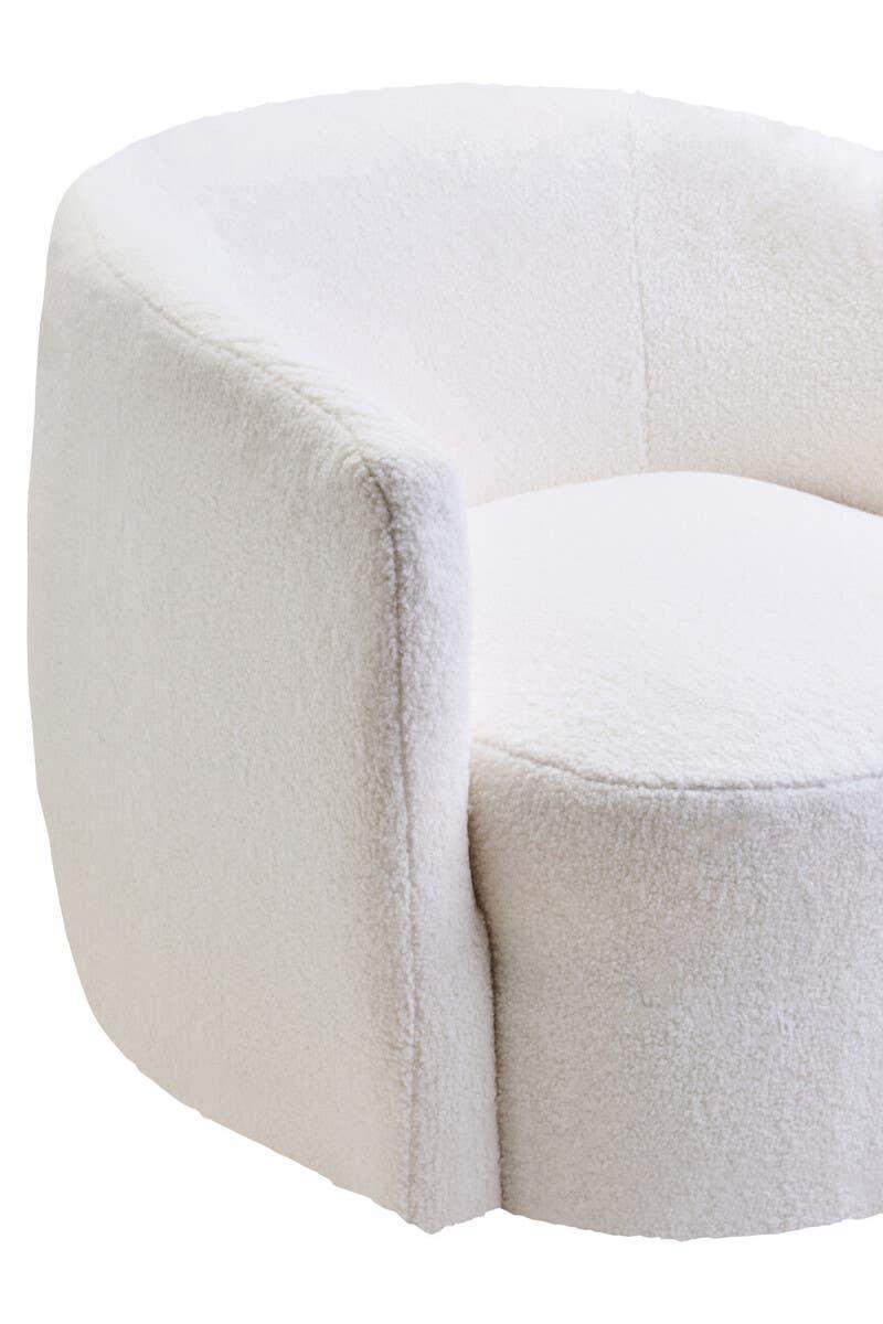 Curved cream boucle armchair with plush upholstery, close-up of seat and backrest