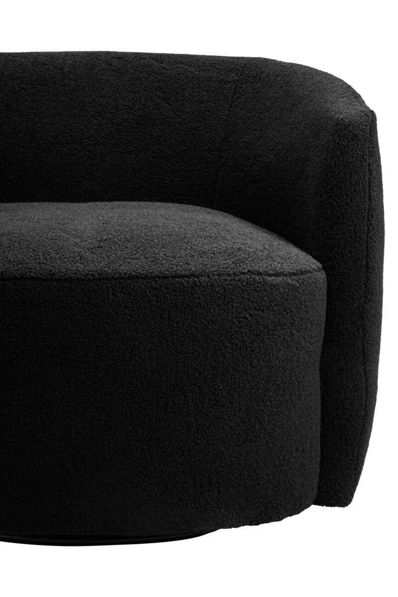 Curved black boucle accent chair with rounded backrest and plush upholstery, close up view