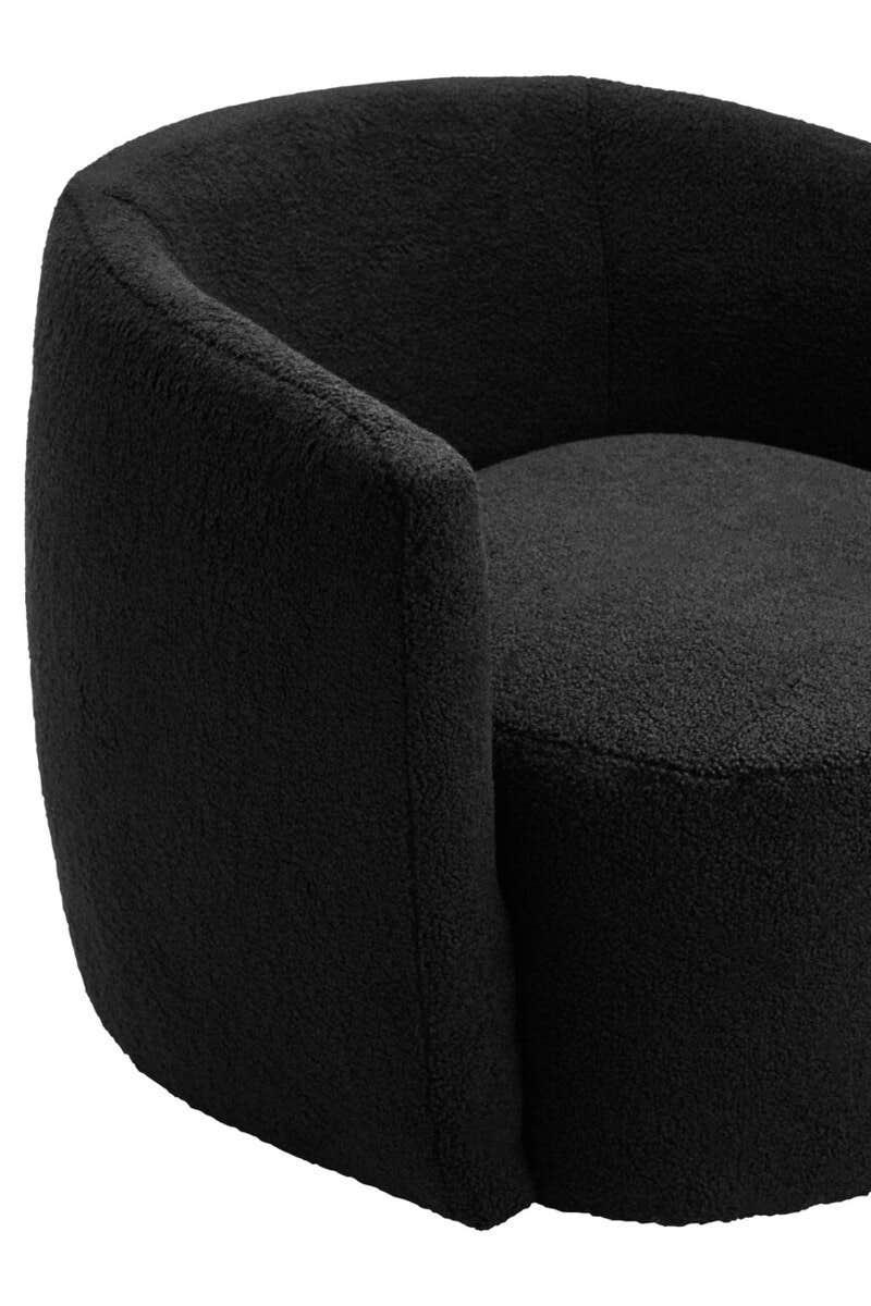 Black boucle accent chair with curved backrest and minimalist design
