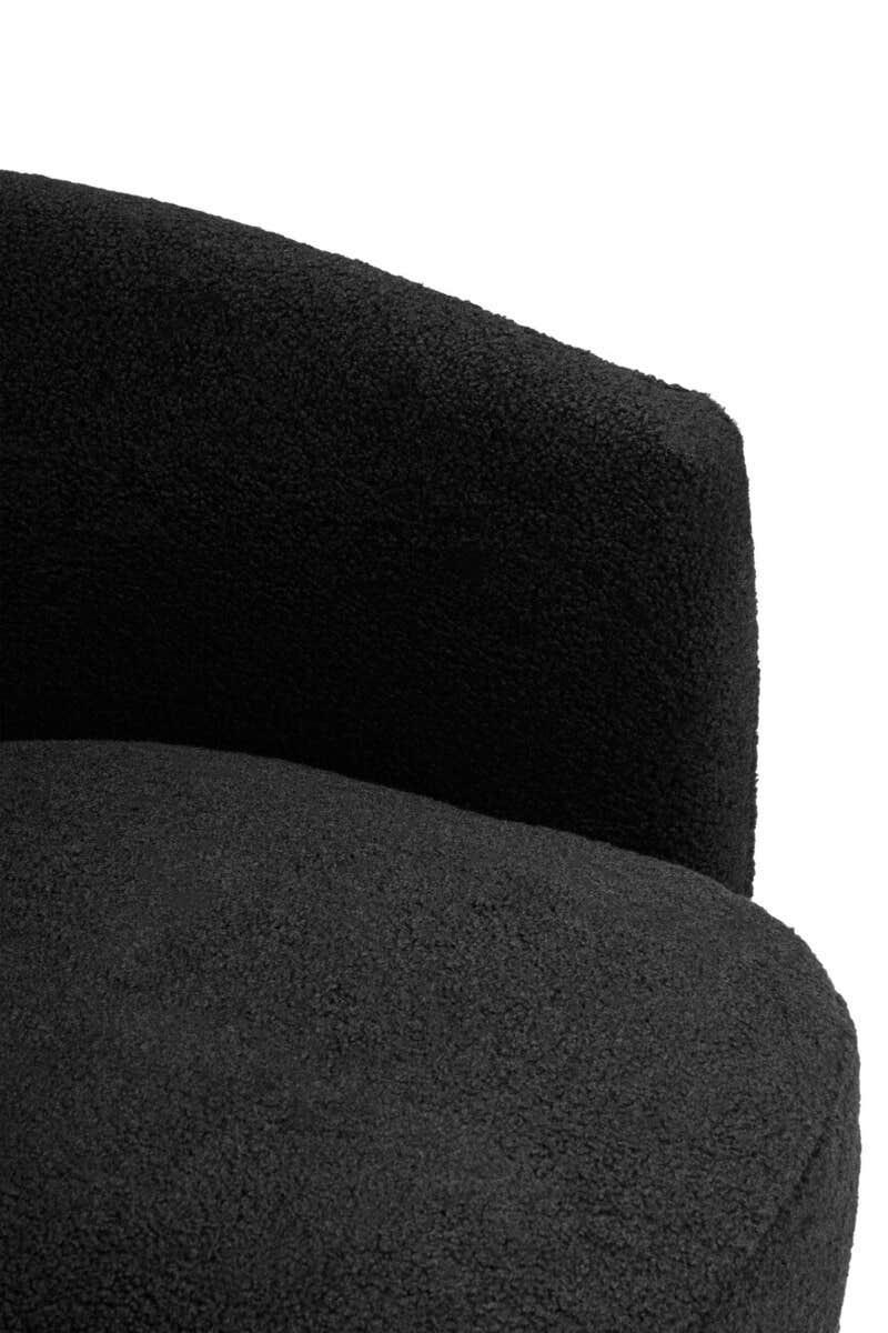 Close-up of textured black fabric accent chair with curved backrest