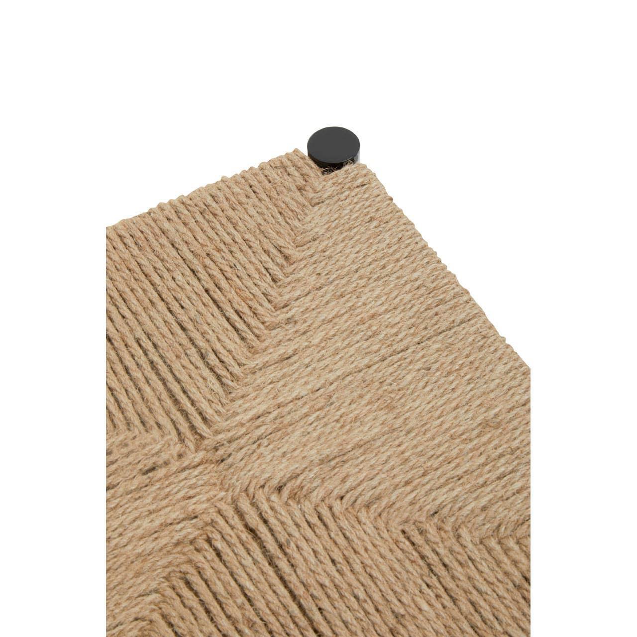 Close-up of woven rope tabletop with black metal corner accent