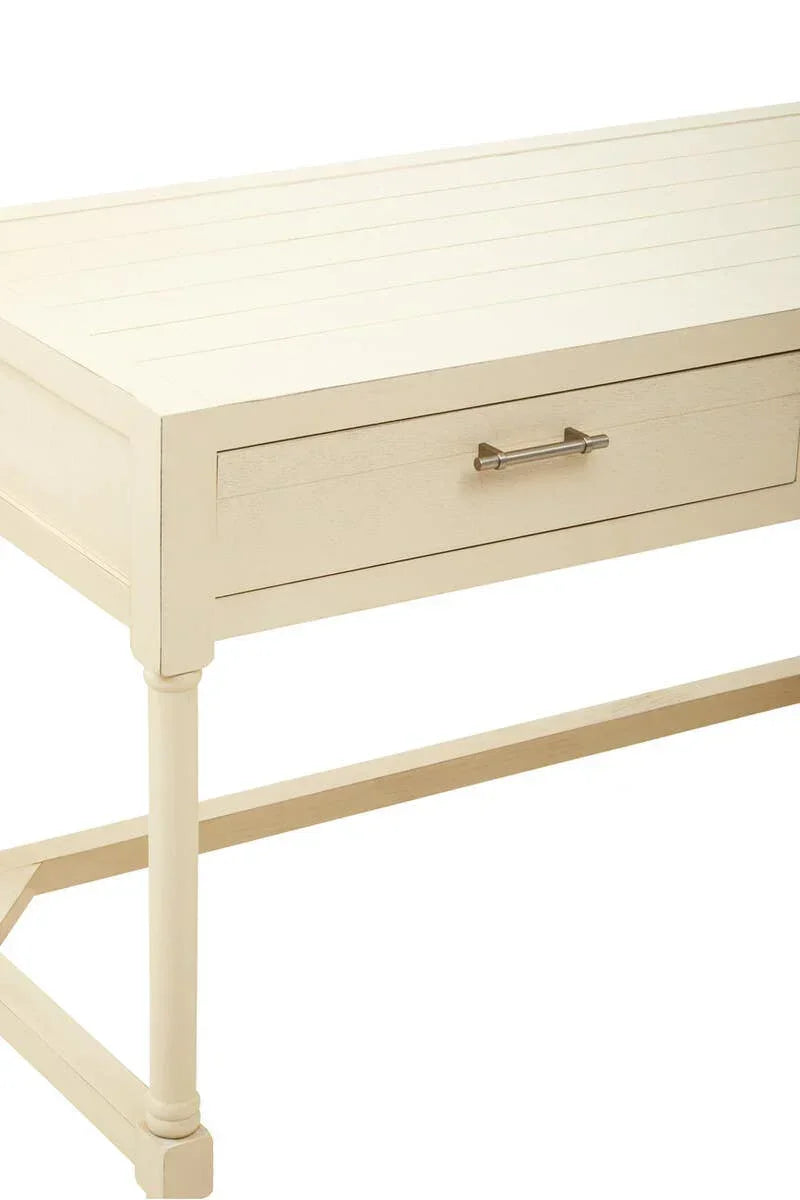Cream wooden desk with single drawer and metal handle, slatted top, partial side view