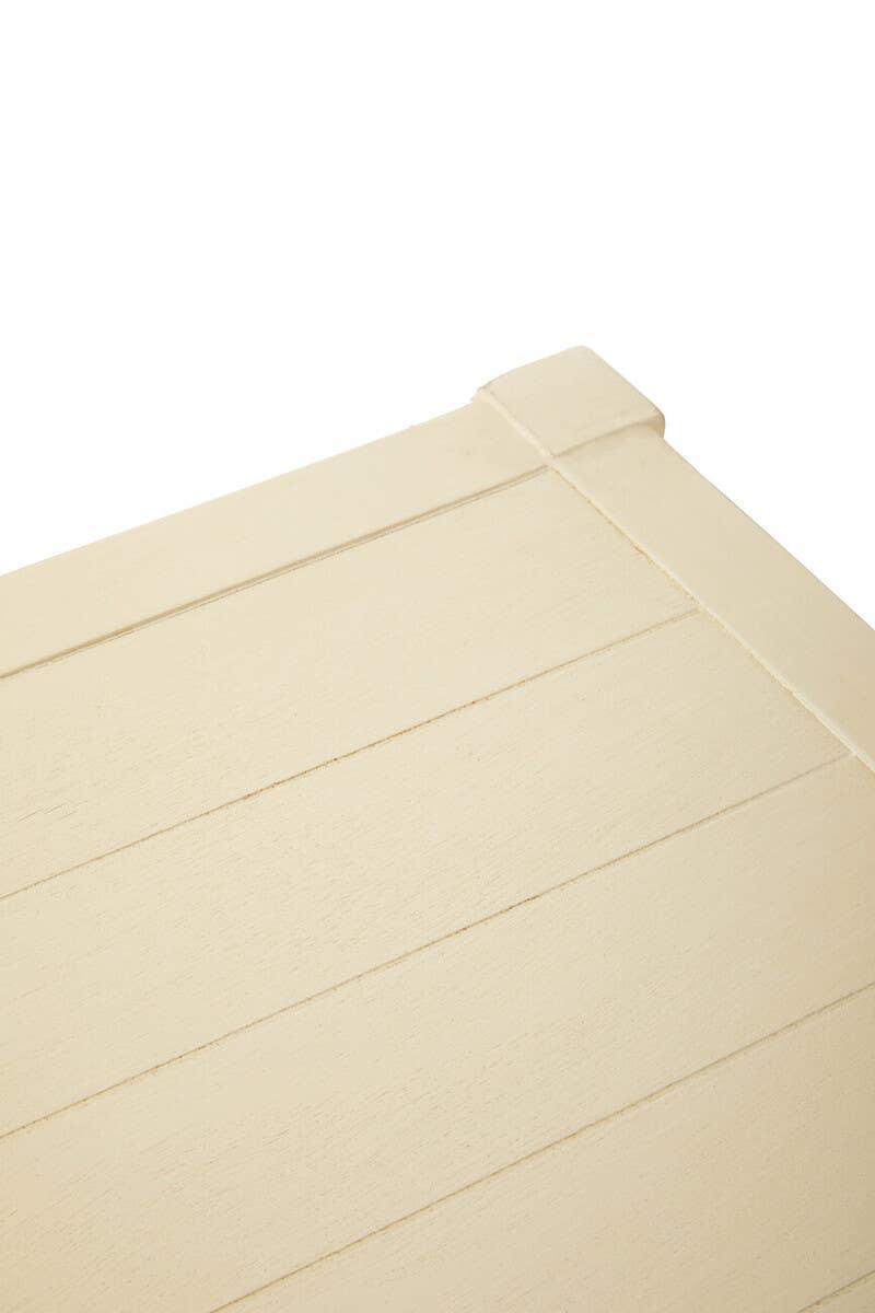 Close-up of cream painted wooden table corner with slatted surface detail