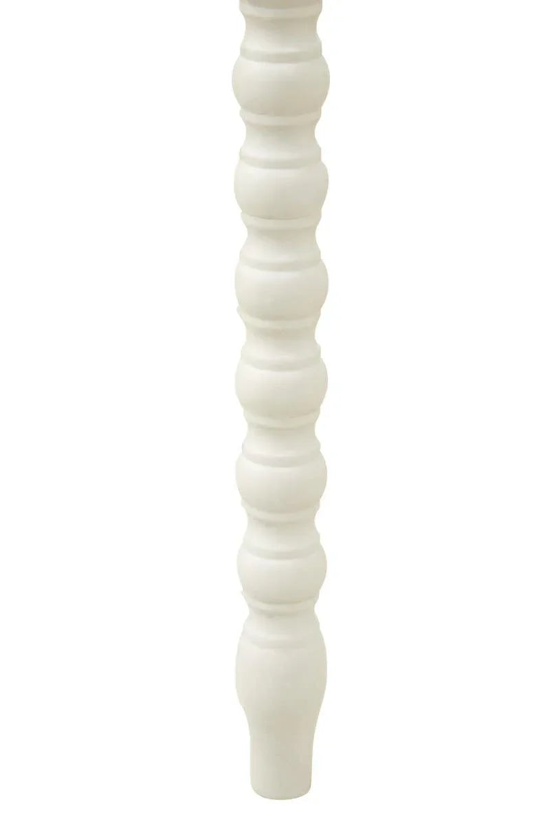 White wooden furniture leg with turned spindle design, close-up view