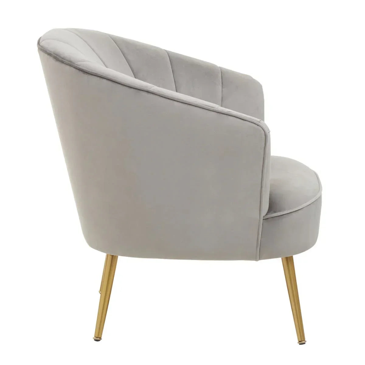 Grey velvet accent chair with gold legs, side view highlighting curved backrest design