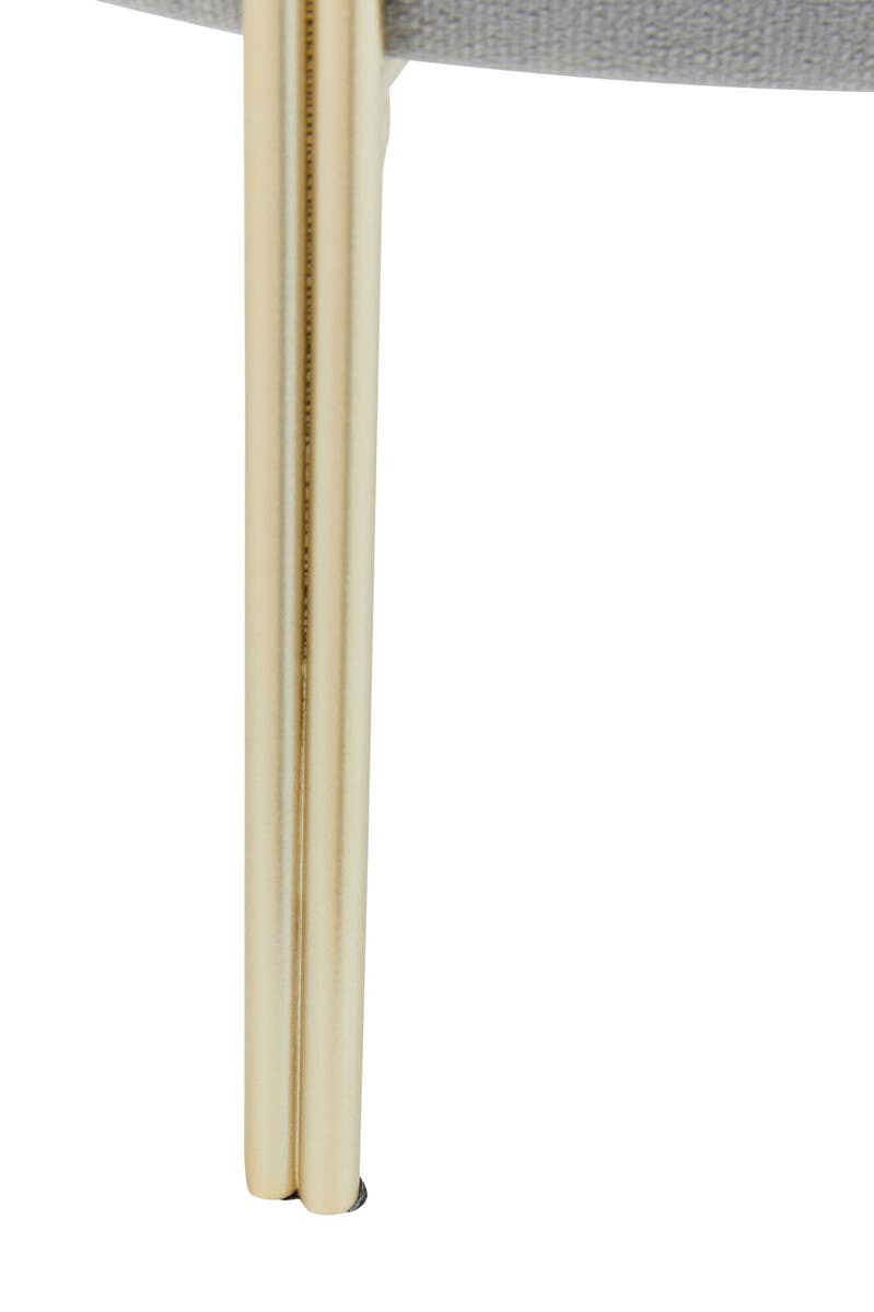 Round grey velvet stool featuring a plush seat and sleek gold metal legs, showcasing a modern and elegant design suitable for home decor