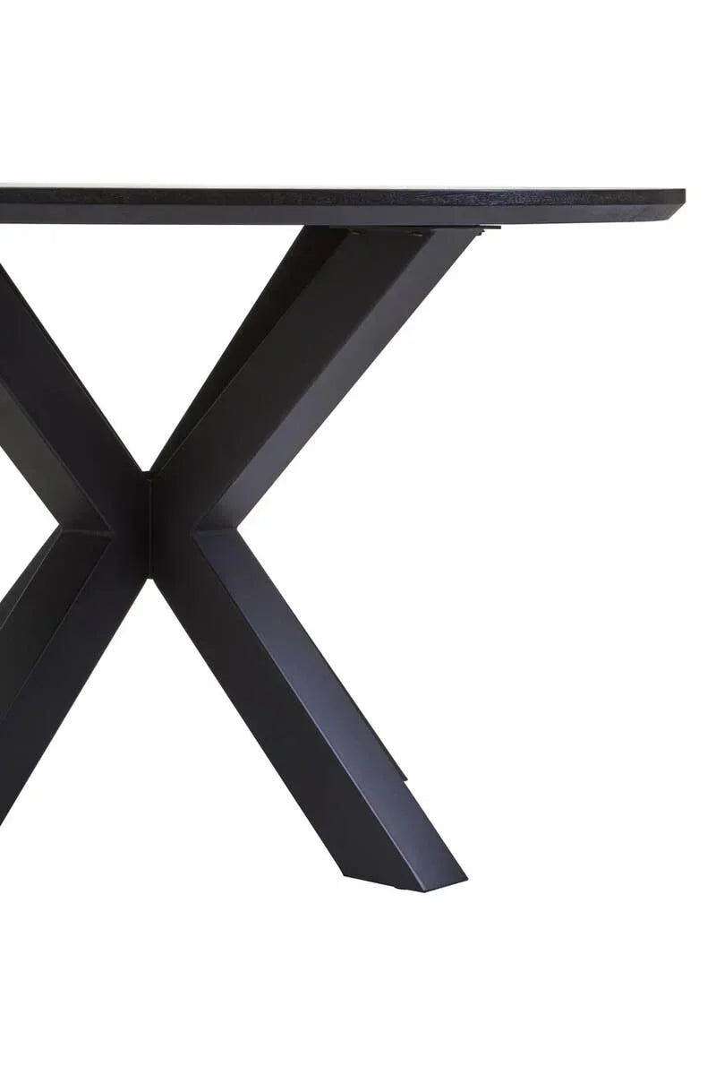 Black dining table with thick rectangular top and X-shaped metal base
