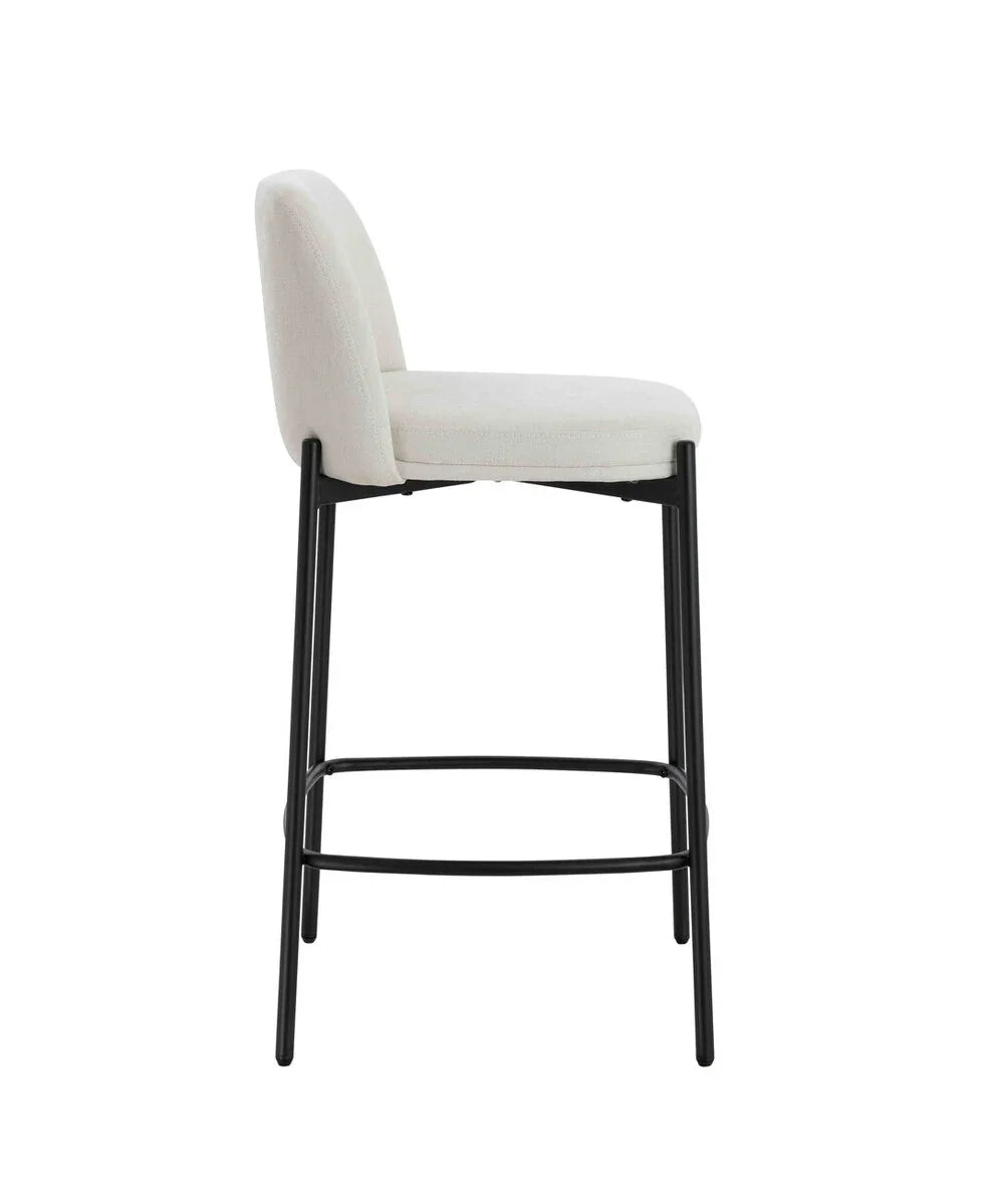 Cream upholstered bar stool with black metal legs shown from the side