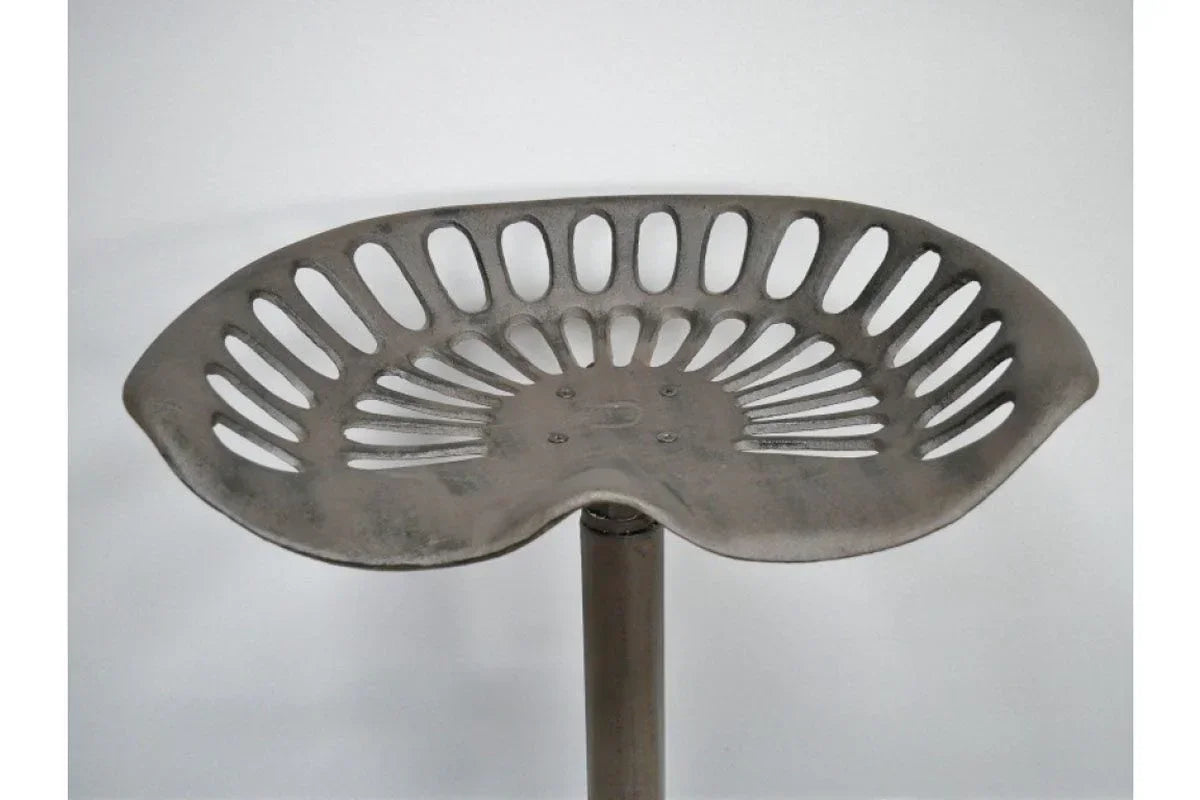 Industrial metal bar stool seat with openwork design against plain background